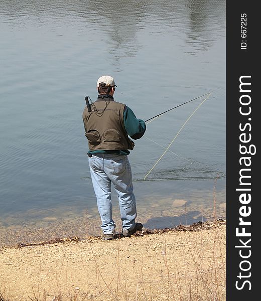 Man with fishing pole fishing. Man with fishing pole fishing