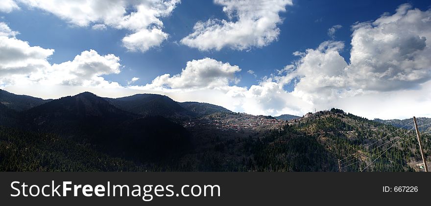 Nice dramatic clouds and high mountains form the environment for this little village in Greece (Ano Chora Nafpaktias). Nice dramatic clouds and high mountains form the environment for this little village in Greece (Ano Chora Nafpaktias)