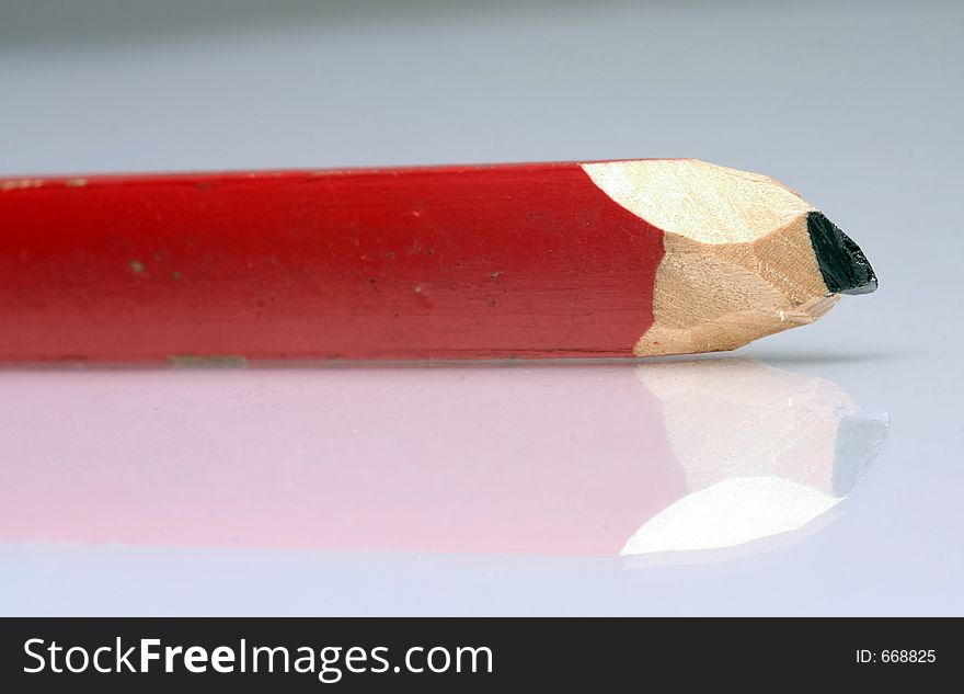 Macro of red slate pencil with reflex. Macro of red slate pencil with reflex