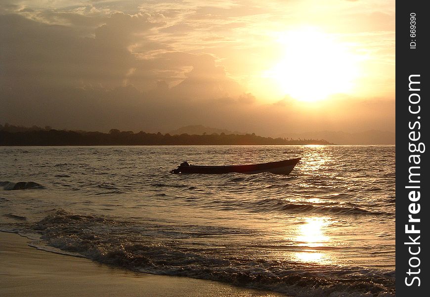 A boat remains near the beach in the tropics. A boat remains near the beach in the tropics