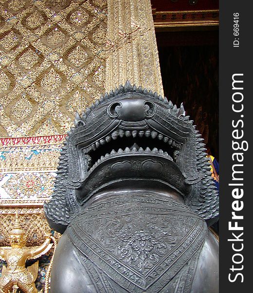 A Thai statue in front of a temple. A Thai statue in front of a temple