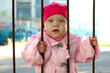 Little Girl Behind Old Railing (grille). Royalty Free Stock Photos Little Girl Behind Old Railing (grille). Royalty Free Stock Photos