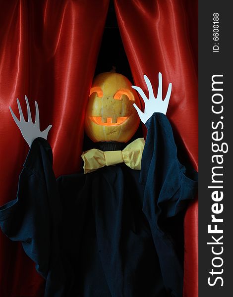 Halloween scarecrow on background with red drop-curtain. Halloween scarecrow on background with red drop-curtain