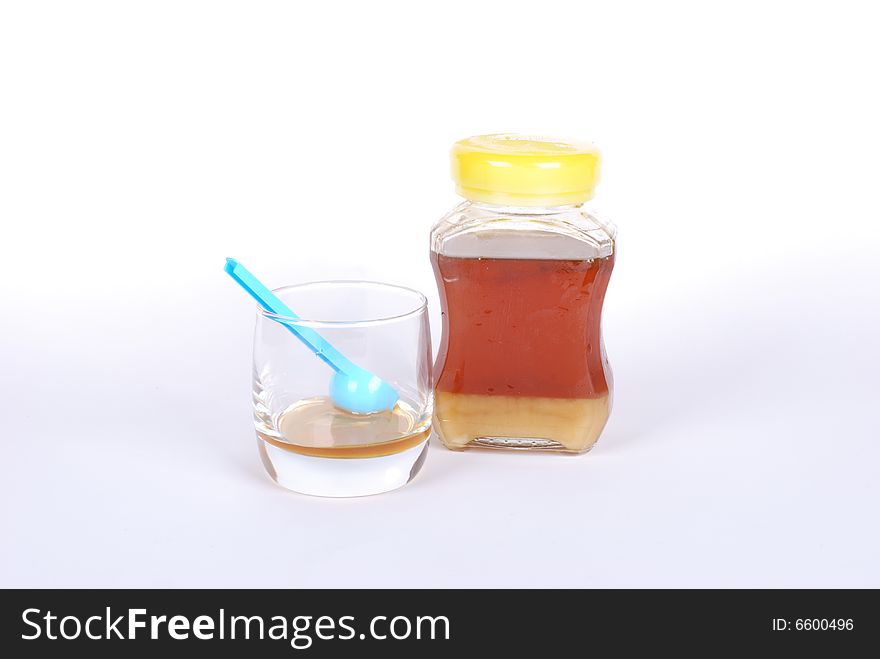 Honey bottle on white background