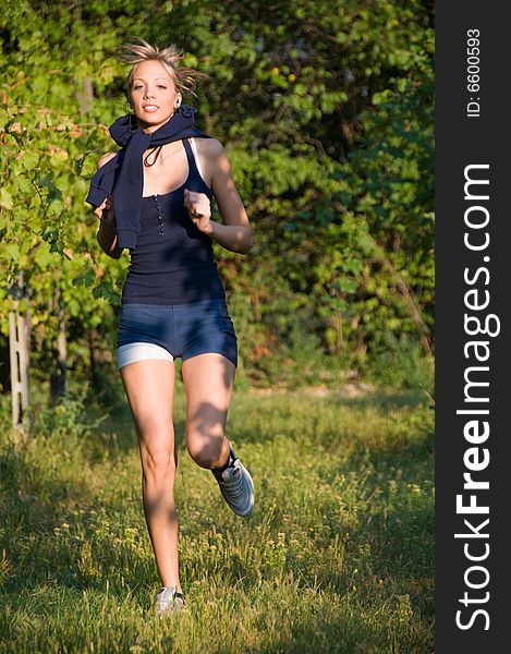 Young and athletic blond girl, running between the vineyards in a beautiful summer day. Young and athletic blond girl, running between the vineyards in a beautiful summer day.