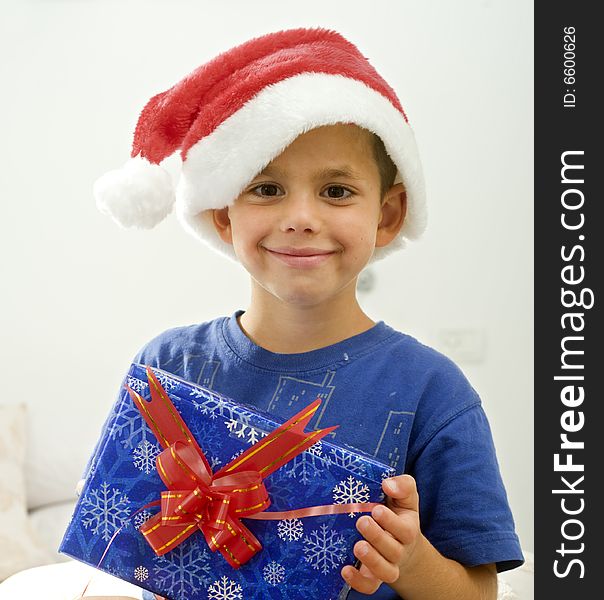 Young boy with Christmas hat and presents. Young boy with Christmas hat and presents