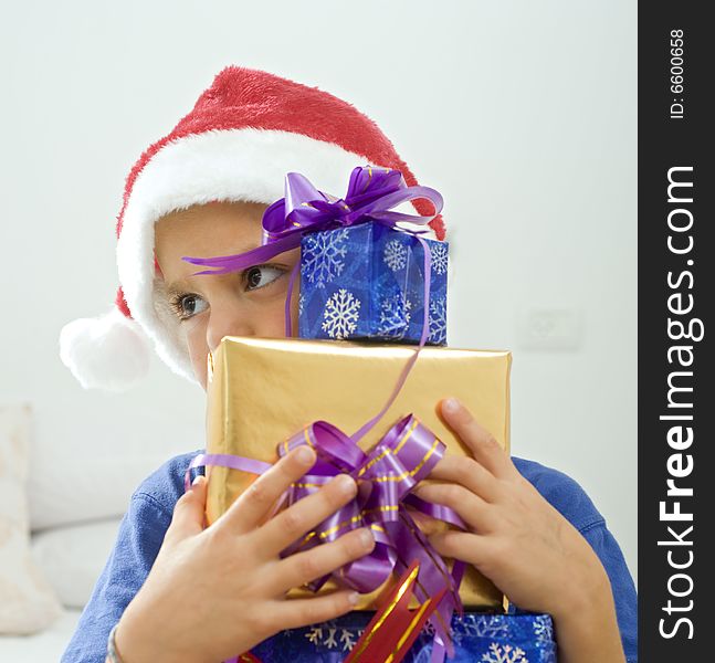 Young boy with Christmas hat and presents. Young boy with Christmas hat and presents
