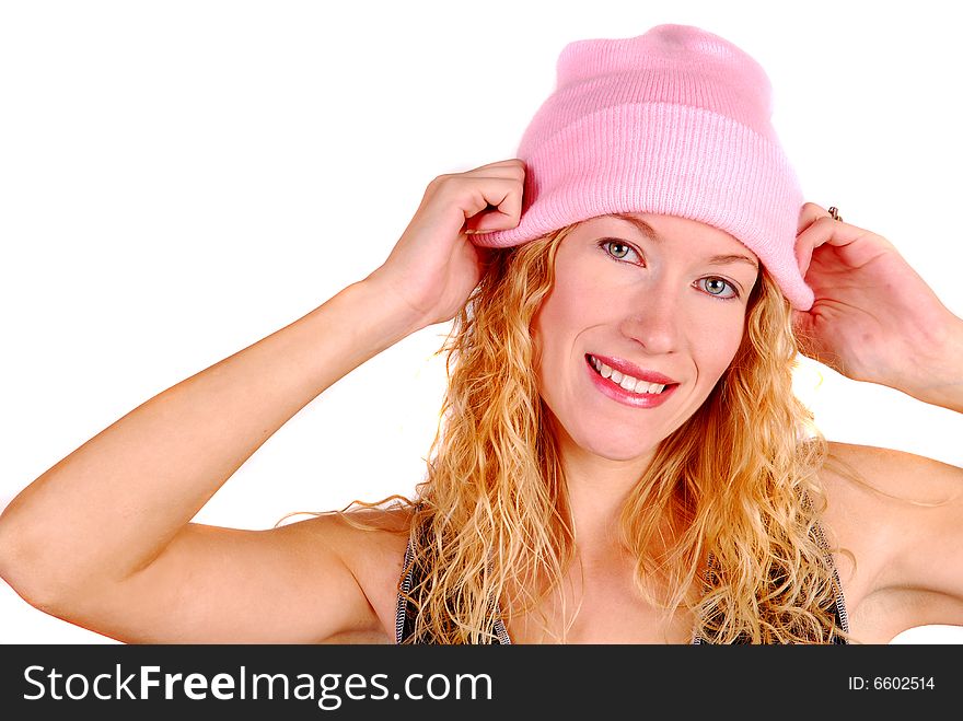 Young attractive woman trying on a pink wool hat. Young attractive woman trying on a pink wool hat