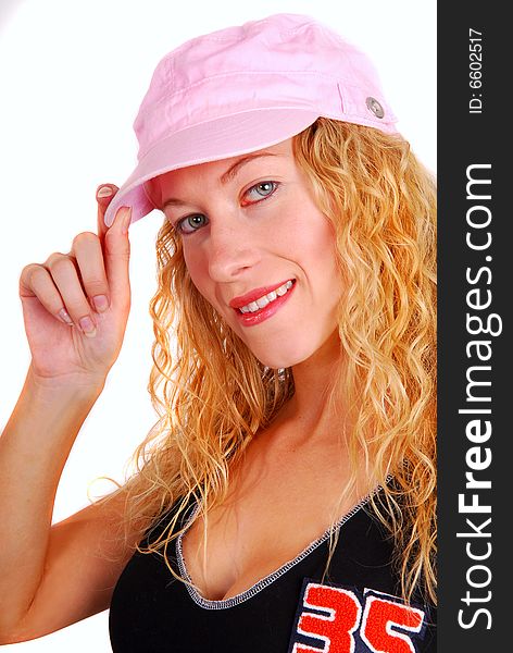 Young attractive woman trying on pink sports cap. Young attractive woman trying on pink sports cap