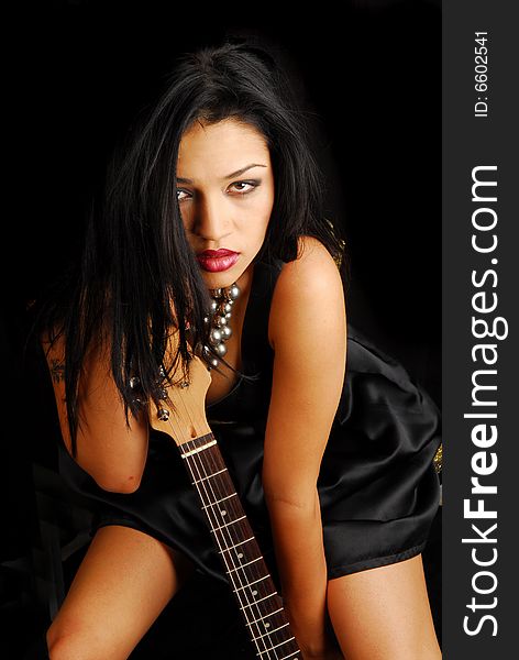 Attractive female rocker with her guitar. Attractive female rocker with her guitar