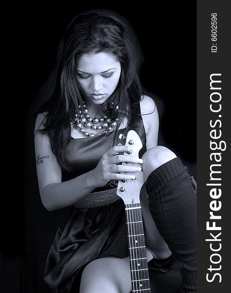 Black & white image of female rocker with her guitar. Black & white image of female rocker with her guitar