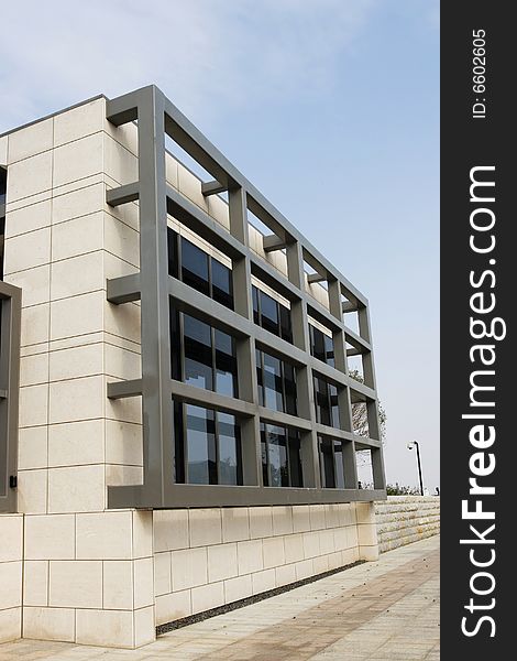 The modern building with a blue sky background .