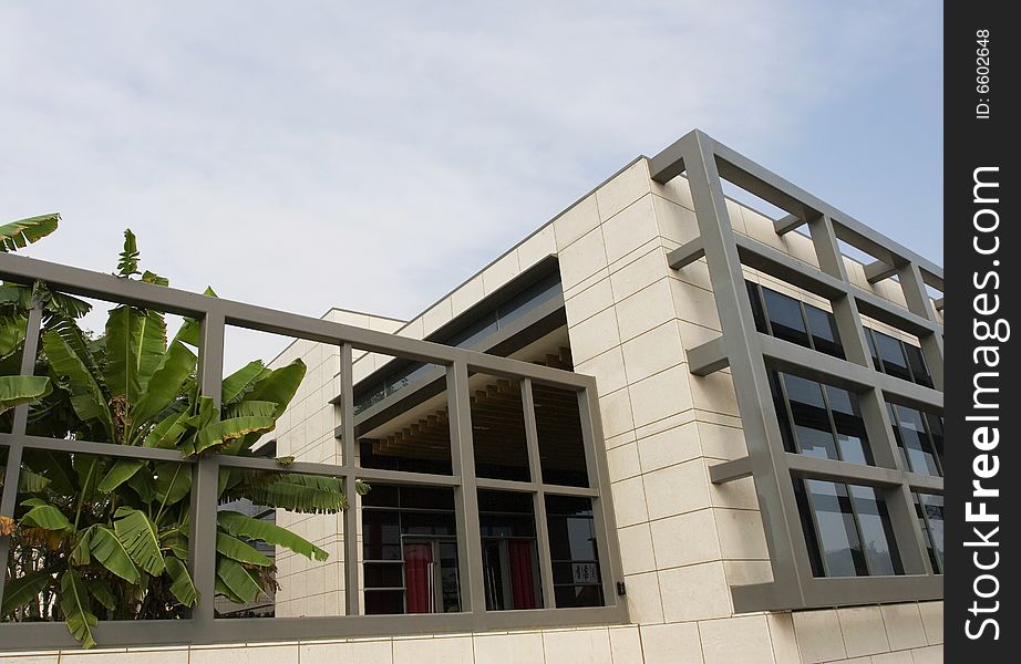 The modern building with a blue sky background .