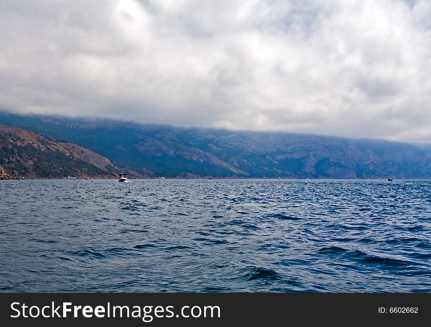 Calm sea, storm clouds, overcast.