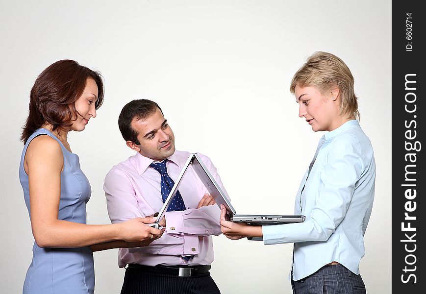 Three colleagues working at a computer