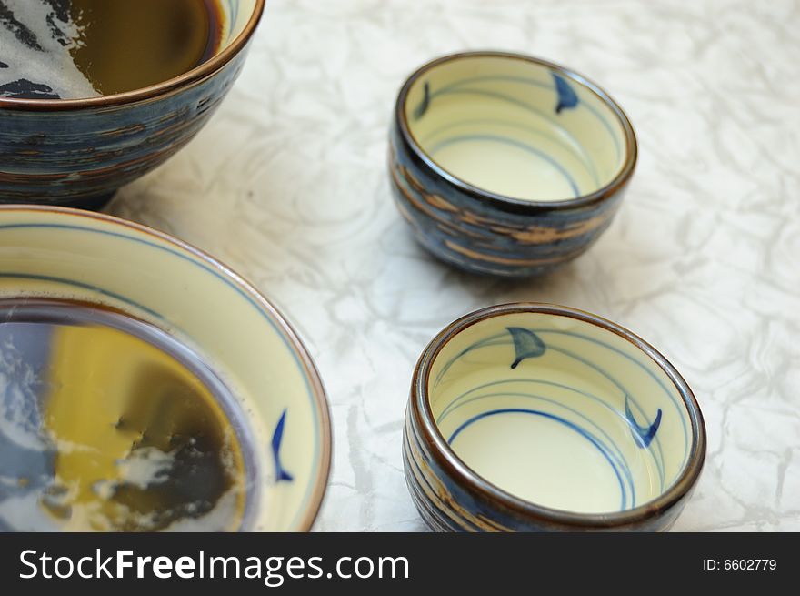 Four asian bowls on the table - sake and soup with soy