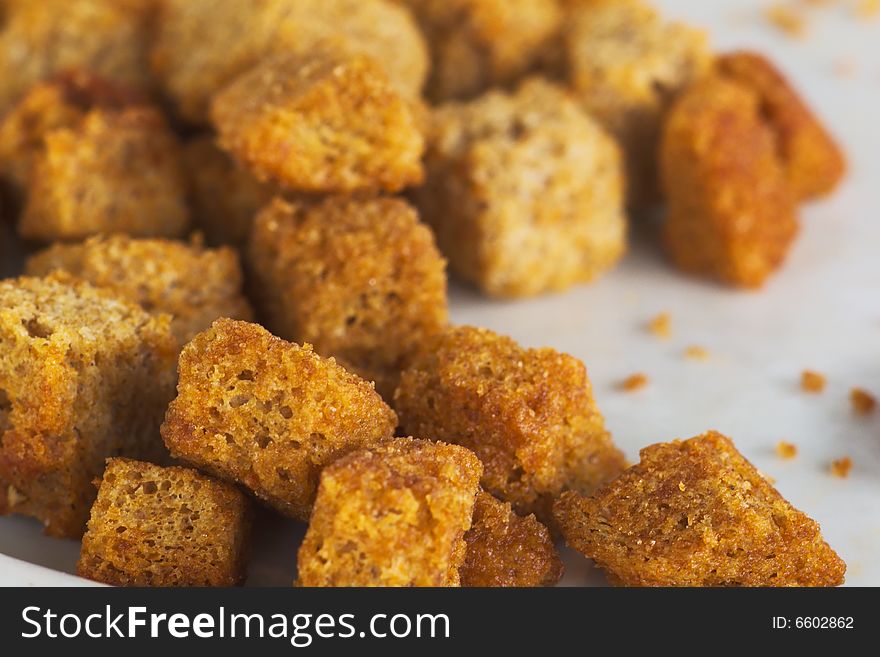 Encrusted dried bread bits snack on the plate. Encrusted dried bread bits snack on the plate