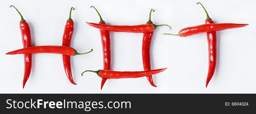 Red Chillies in the shape of hot on white. Red Chillies in the shape of hot on white