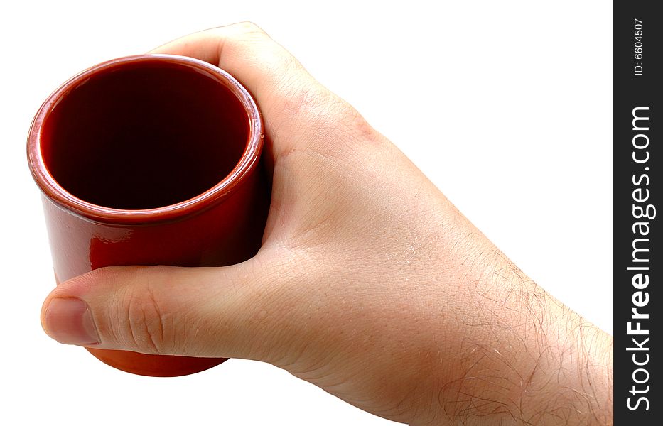 Pottery cup for tea or coffee in man's hand on isolated background. Pottery cup for tea or coffee in man's hand on isolated background.