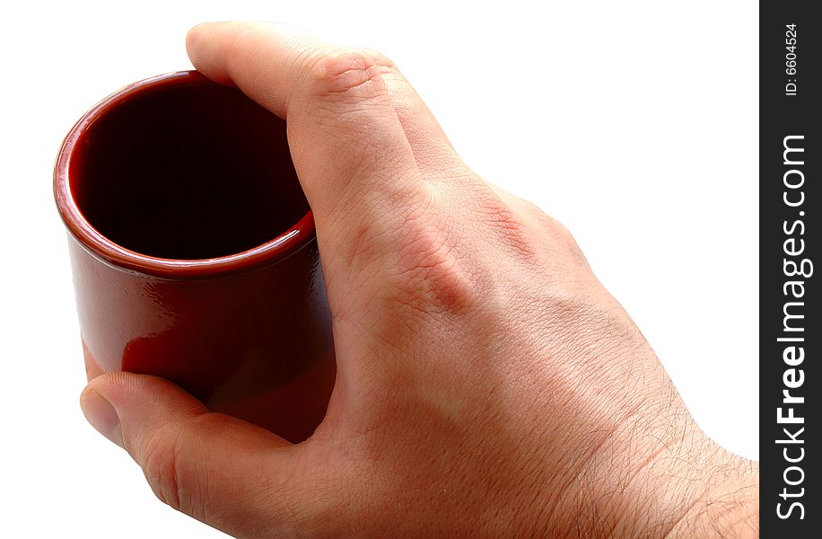 Pottery cup for tea or coffee in man's hand on isolated background. Pottery cup for tea or coffee in man's hand on isolated background.