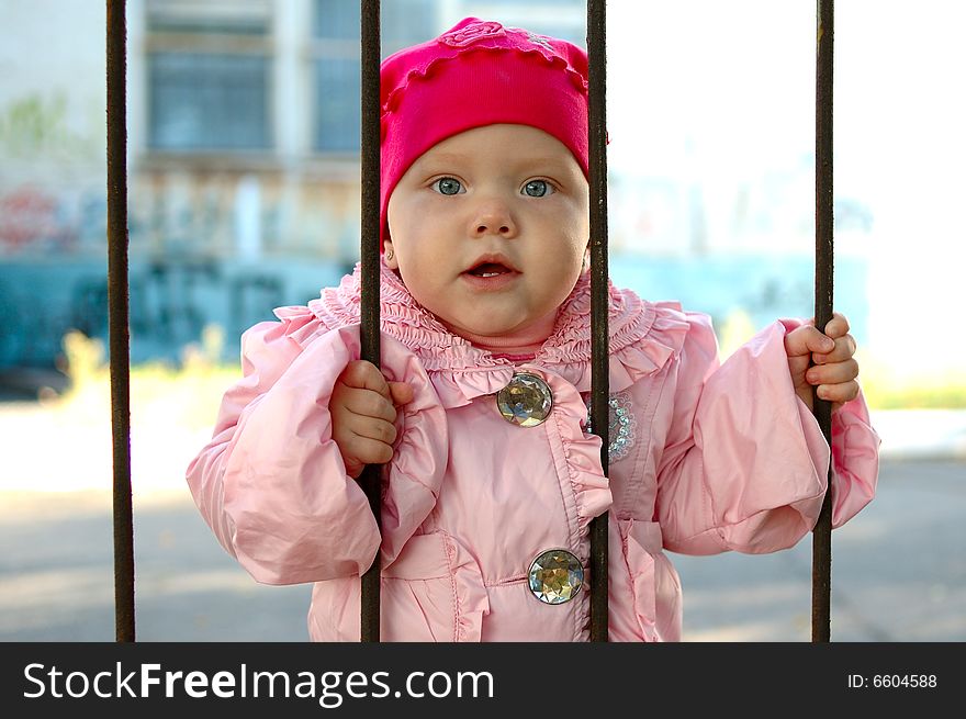 Little Girl Behind Old Railing (grille).