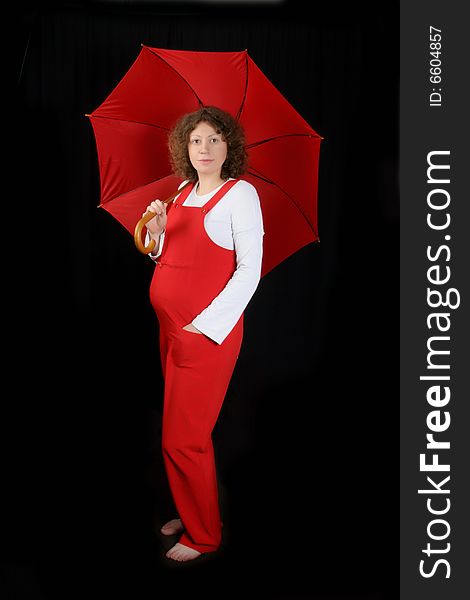 Young pregnant with red umbrella