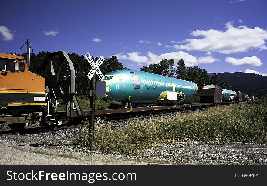 Airplane fuselages travel by way of railcar. Airplane fuselages travel by way of railcar.