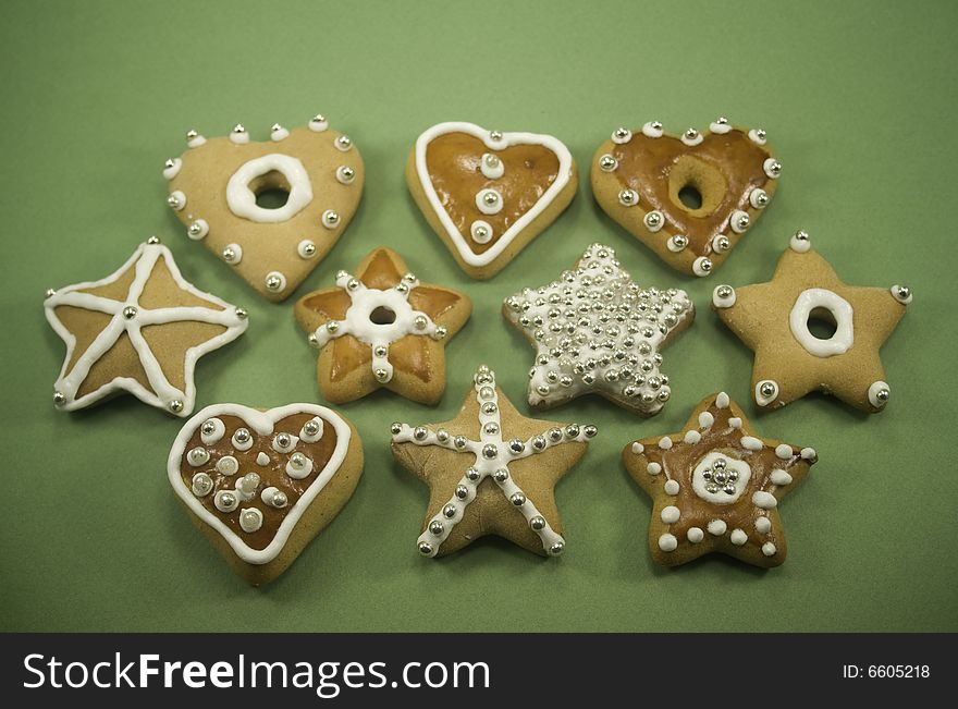 Decorated star and heart cookies on green paper. Decorated star and heart cookies on green paper