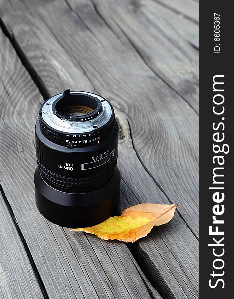 Camera lense and autumn leaf