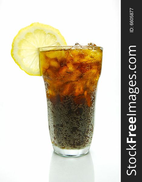 A glass of lemon cola isolated against a white background