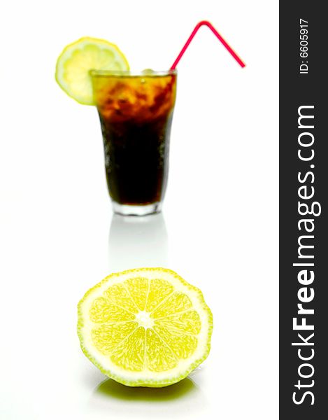 A glass of lemon cola isolated against a white background