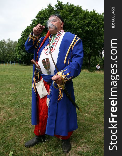 Old ukrainian Cossack with long whiskers smoking pipe. Old ukrainian Cossack with long whiskers smoking pipe