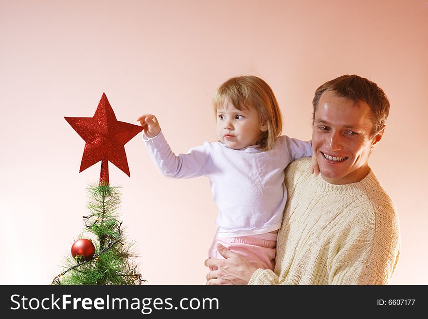 Father and daughter near christmas tree