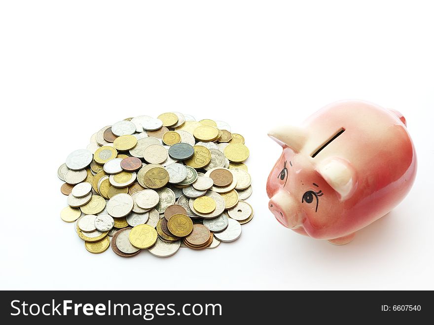 Pink piggy bank isolated on white background with coins