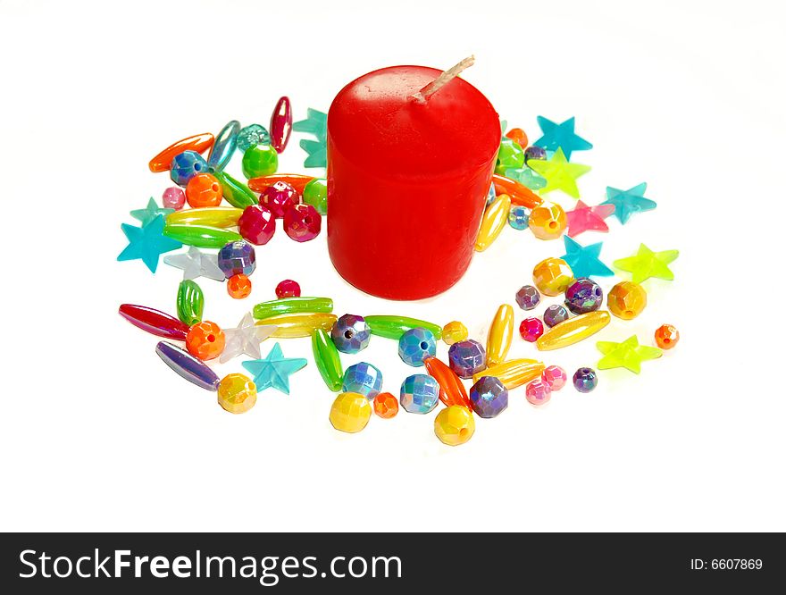 Red candle in white beads isolated over white