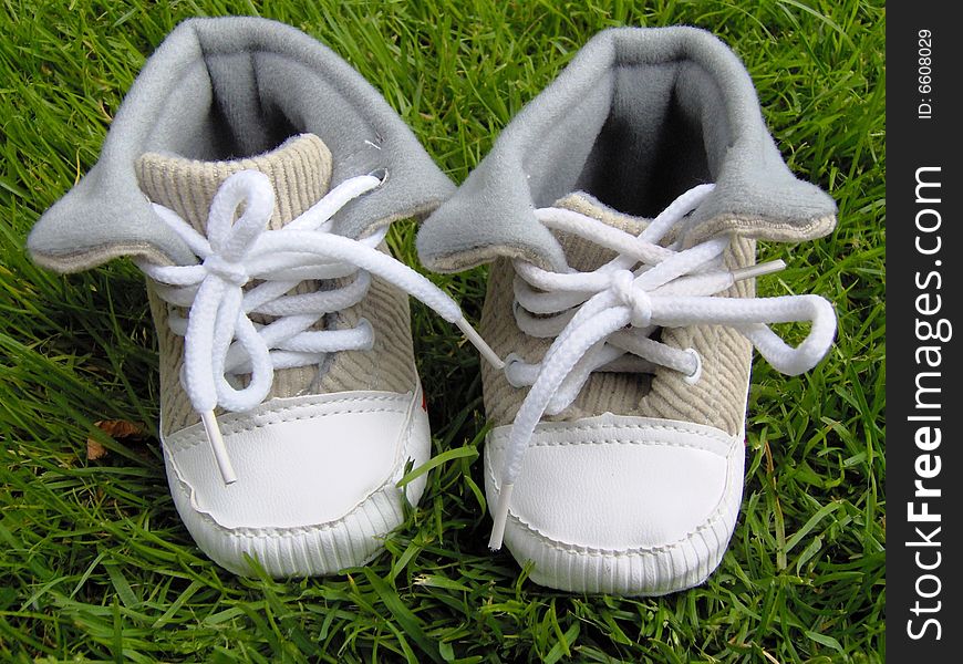 cute baby shoes on the grass in the garden