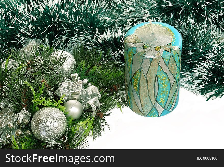 Decorative candle over green new year adorning. Decorative candle over green new year adorning