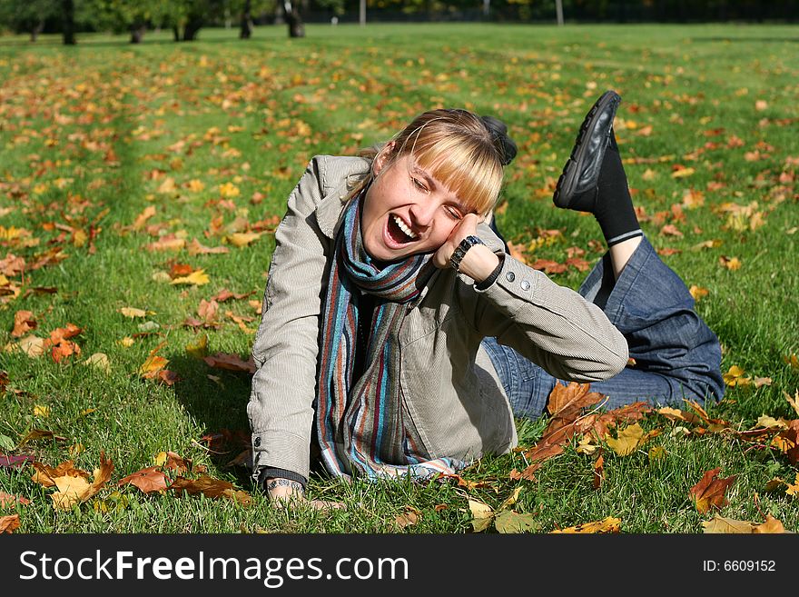 Beautiful blond young woman in autumn park