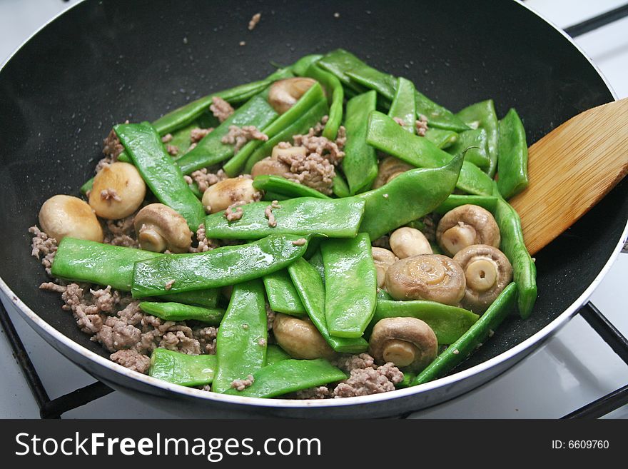 Fresh meat, beans and mushrooms in a pan. Fresh meat, beans and mushrooms in a pan