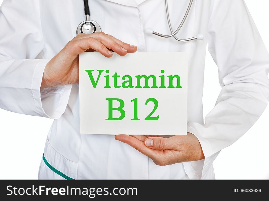 Vitamin B12 written on a card in doctors hands