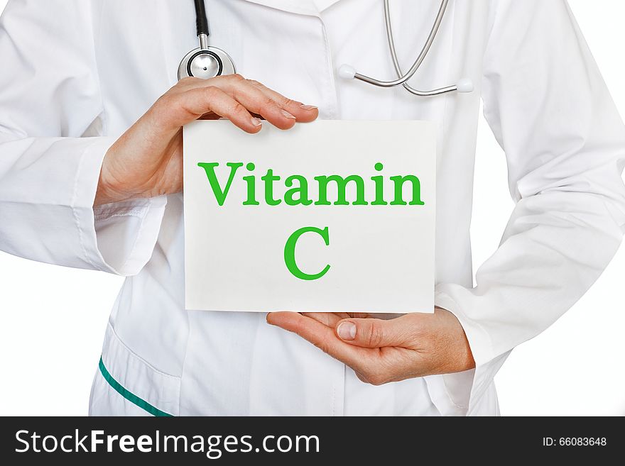 Vitamin C written on a card in doctors hands