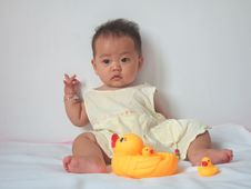Pretty Baby And Toy Ducks Stock Photography