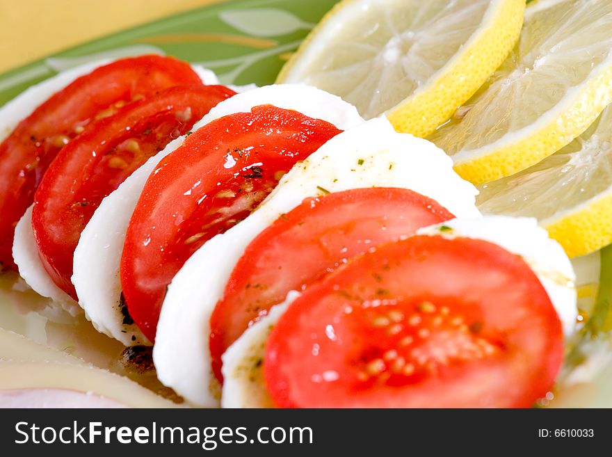 Tasty tomato mozzarella salad dish and some salad dressing. Tasty tomato mozzarella salad dish and some salad dressing