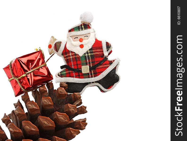 Christmas santa with gift box over a pine cone