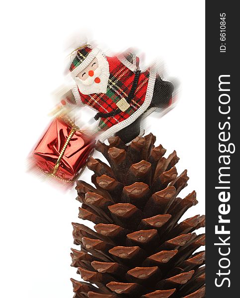 Christmas santa with gift box over a pine cone