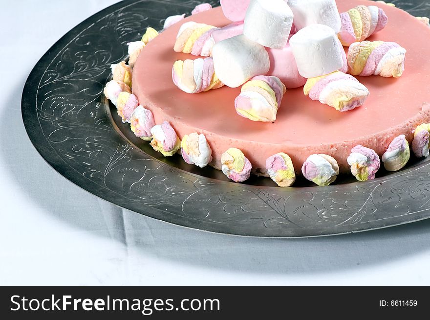 Marshmallow cheese cake on a silver platter.  The cake is made from cream cheese, marsh mellows, digestive biscuits (cookies), butter and cream.