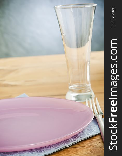 Empty plate and glass on the wooden table. Empty plate and glass on the wooden table