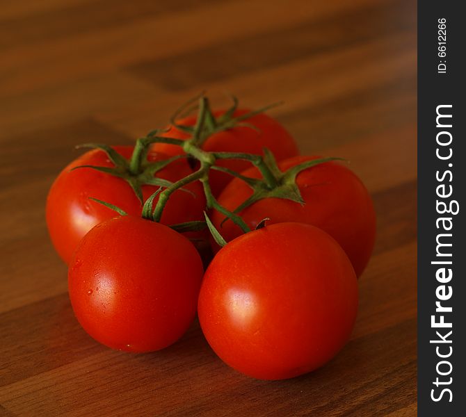 Vine Ripened tomatoes on a wooden table top background