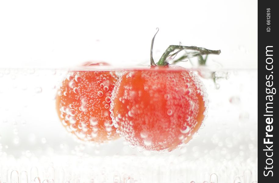 Fresh tomatoes in sparkiling water. Fresh tomatoes in sparkiling water