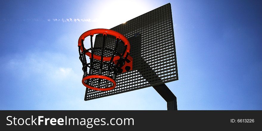 Basketball hoop and backboard set against a blue sky. Basketball hoop and backboard set against a blue sky